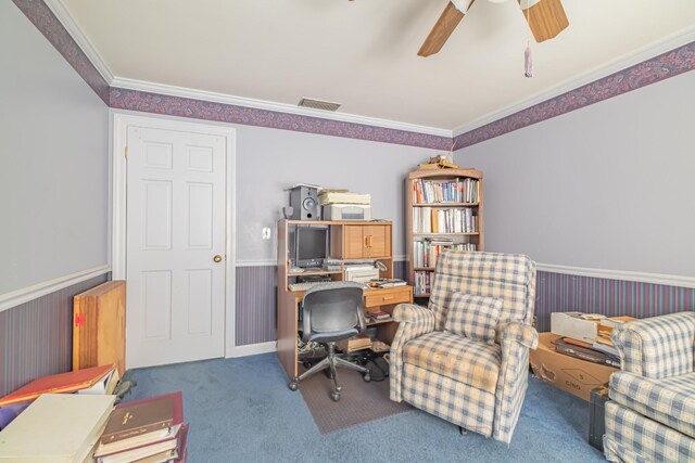 carpeted office space featuring a ceiling fan, ornamental molding, wainscoting, and visible vents