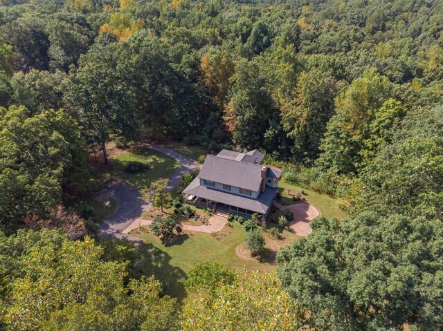 drone / aerial view with a wooded view