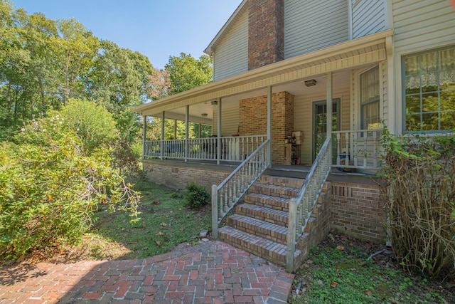 view of exterior entry with covered porch