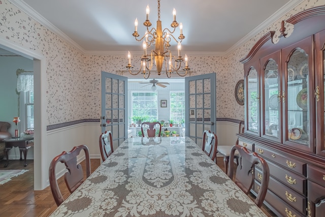 dining room featuring ceiling fan with notable chandelier, crown molding, and parquet flooring