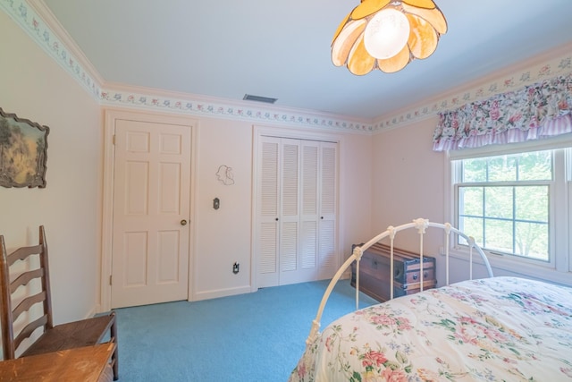 carpeted bedroom with ornamental molding, visible vents, baseboards, and a closet
