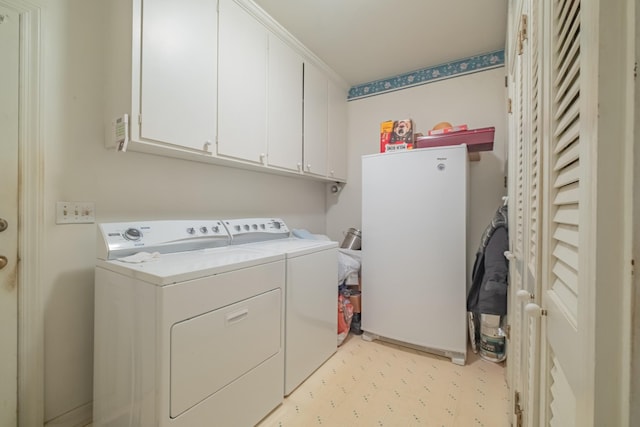 laundry area featuring cabinet space and washing machine and clothes dryer