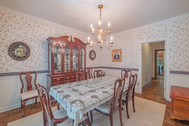 dining space featuring crown molding, wallpapered walls, an inviting chandelier, and a wainscoted wall