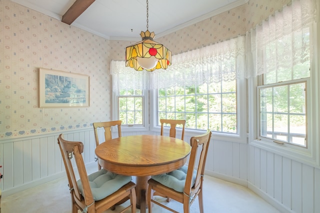 dining room with crown molding and light carpet