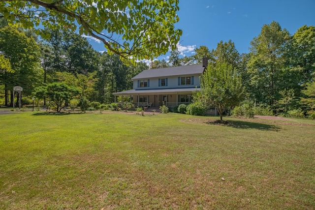 view of front of property with a front yard, a porch, and a chimney