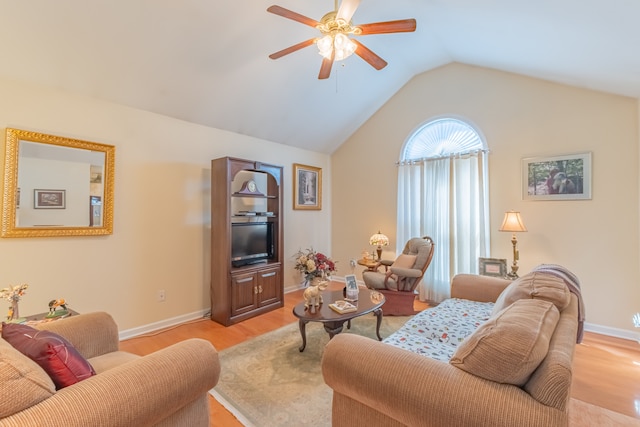 living room featuring ceiling fan, vaulted ceiling, and light hardwood / wood-style floors