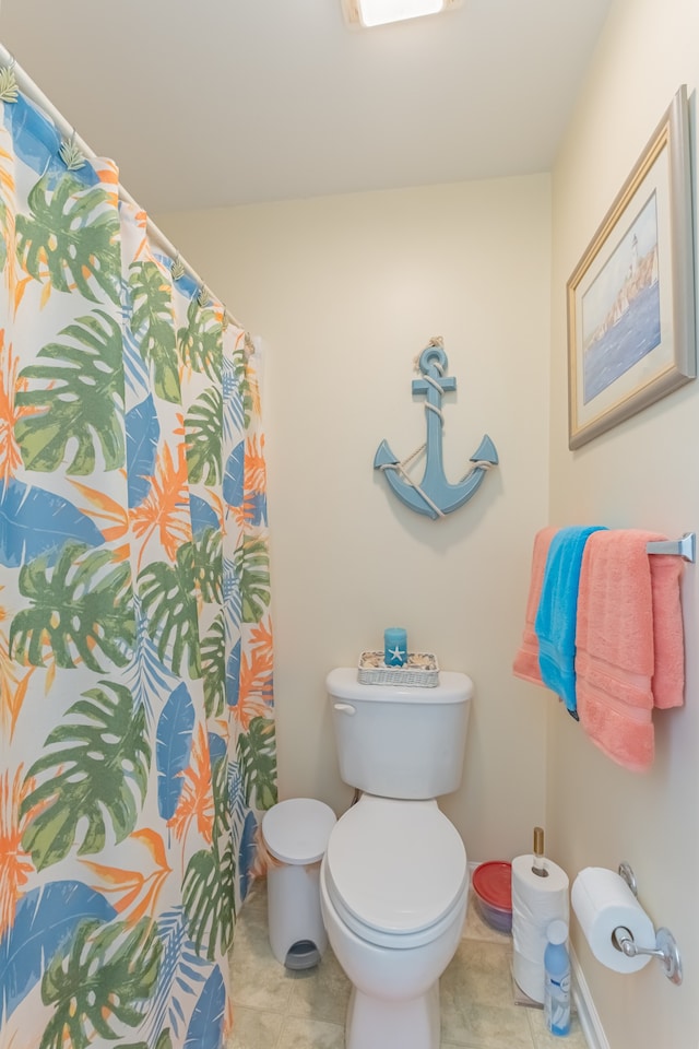 bathroom with toilet and tile patterned floors