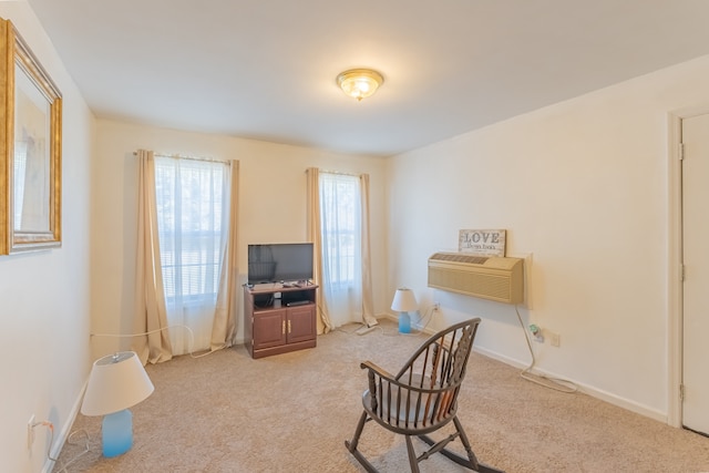 sitting room featuring light carpet and a wall mounted AC