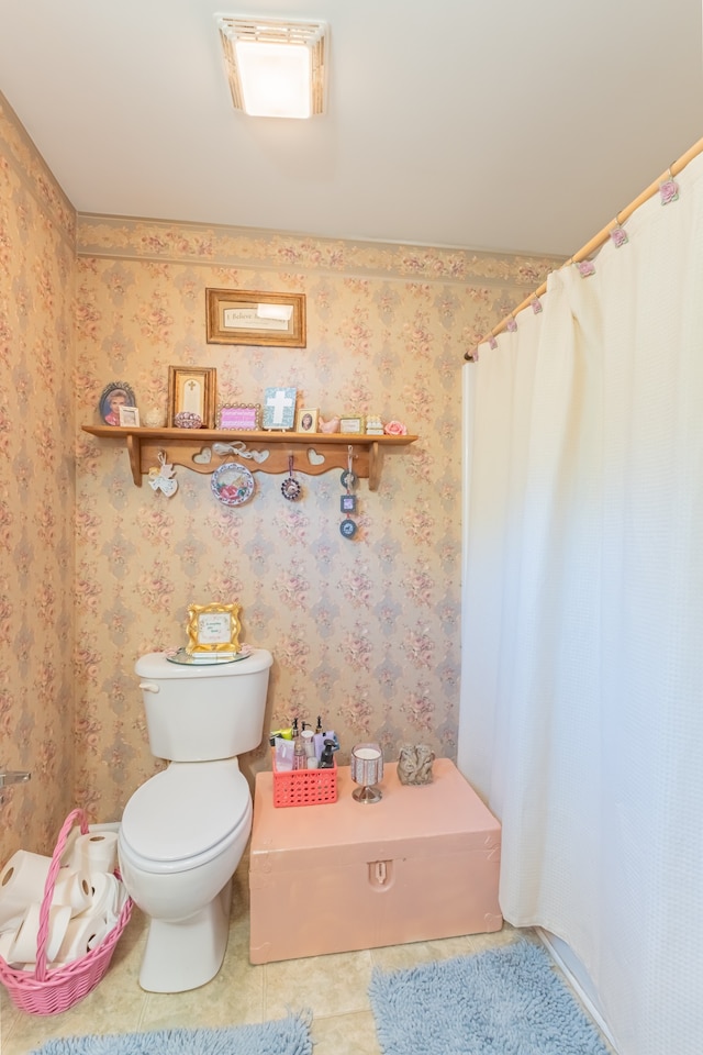 bathroom with toilet, a shower with shower curtain, and tile patterned floors