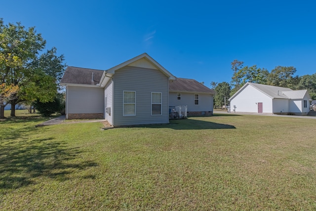 back of property featuring a lawn