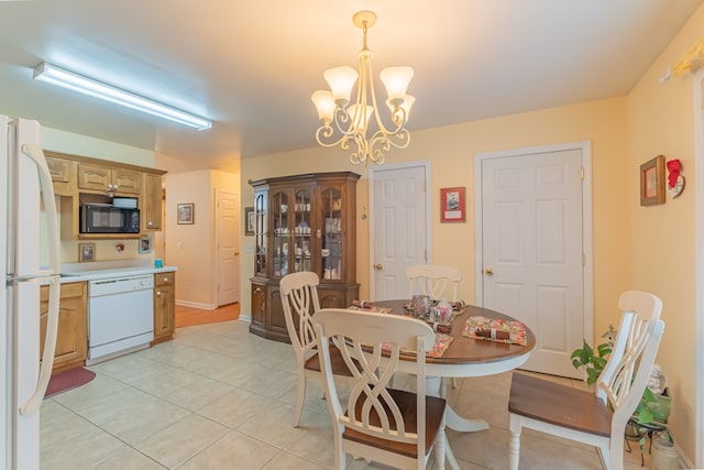 tiled dining space with a notable chandelier