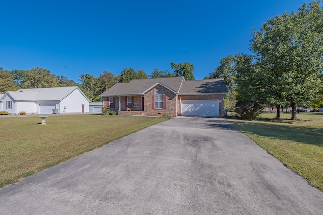 view of front of property with a front yard and a garage