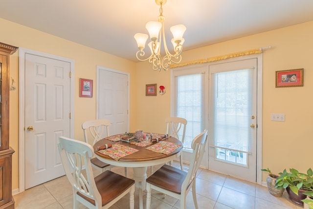 dining area with an inviting chandelier, plenty of natural light, and light tile patterned floors