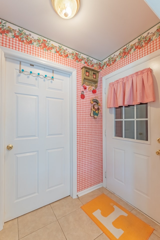 doorway to outside with tile patterned floors