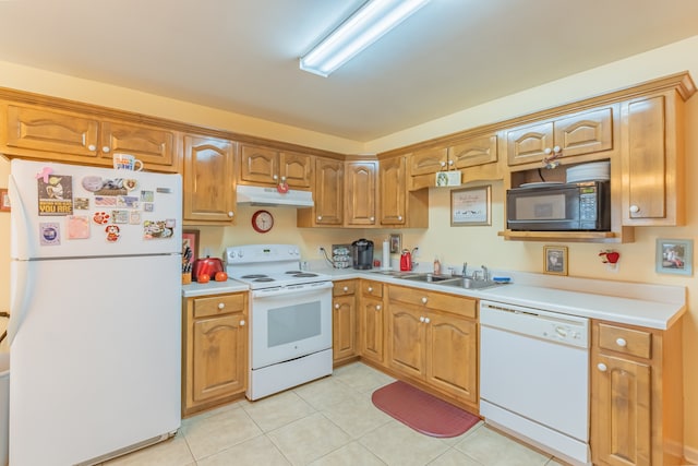 kitchen with white appliances, light tile patterned floors, and sink