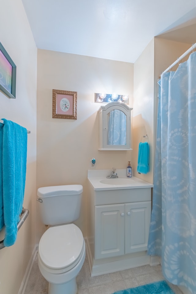 bathroom with vanity, toilet, and tile patterned floors