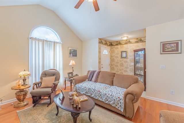 living room with ceiling fan, lofted ceiling, and light hardwood / wood-style floors