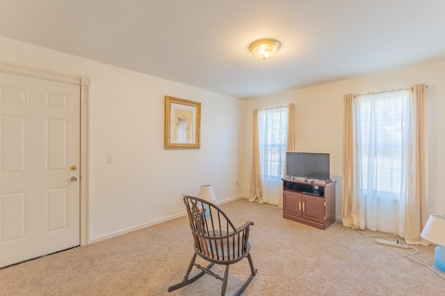 living area with light carpet and a wealth of natural light