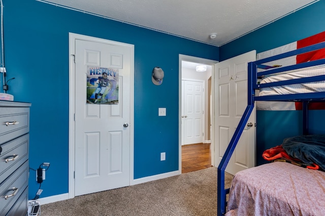 bedroom with a textured ceiling and carpet