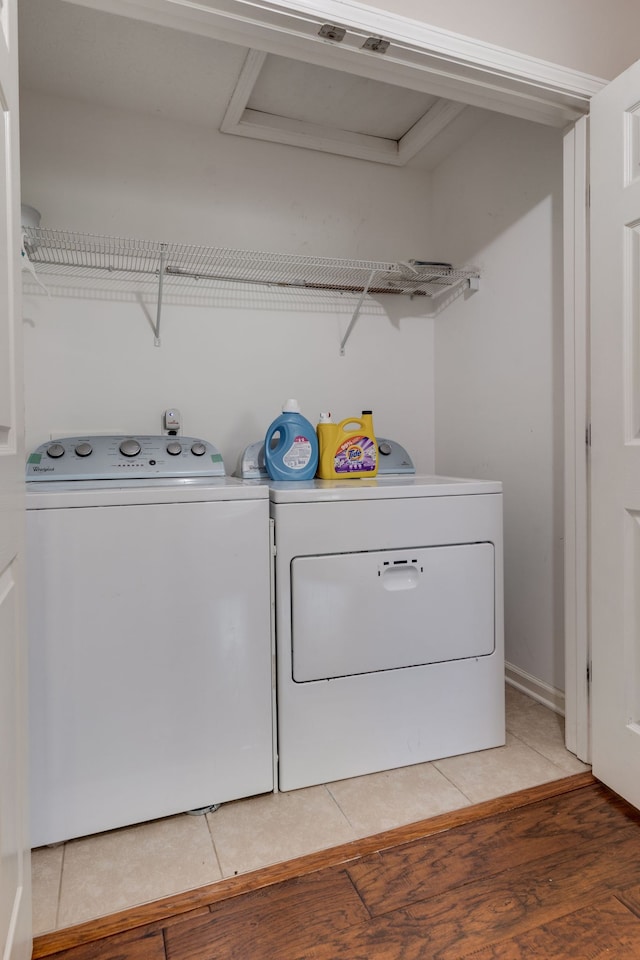 laundry room featuring wood-type flooring and independent washer and dryer