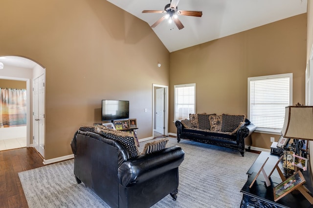 living room featuring hardwood / wood-style floors, ceiling fan, and high vaulted ceiling