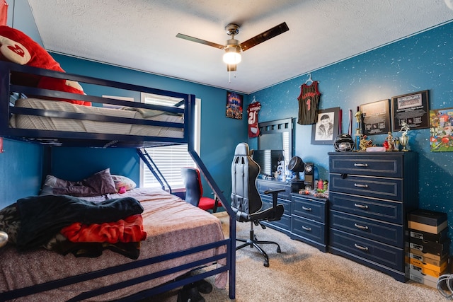 bedroom featuring carpet, ceiling fan, and a textured ceiling