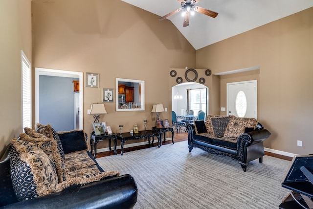 living room with high vaulted ceiling, ceiling fan, and hardwood / wood-style flooring