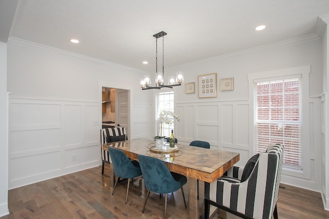 dining space with a notable chandelier, crown molding, and dark hardwood / wood-style flooring