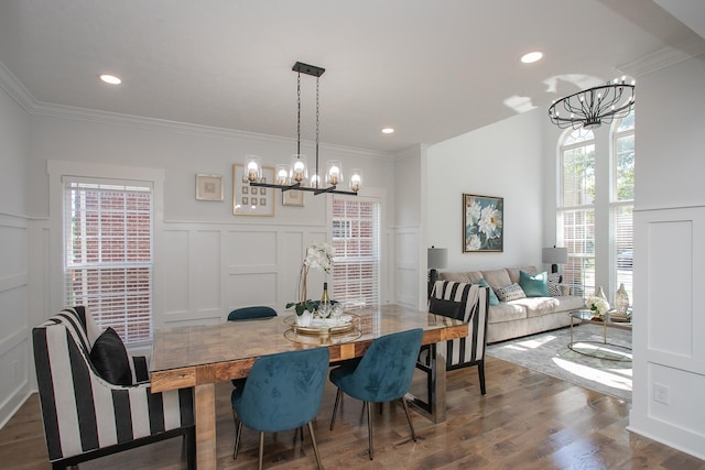 dining room featuring ornamental molding, dark wood-type flooring, and a chandelier