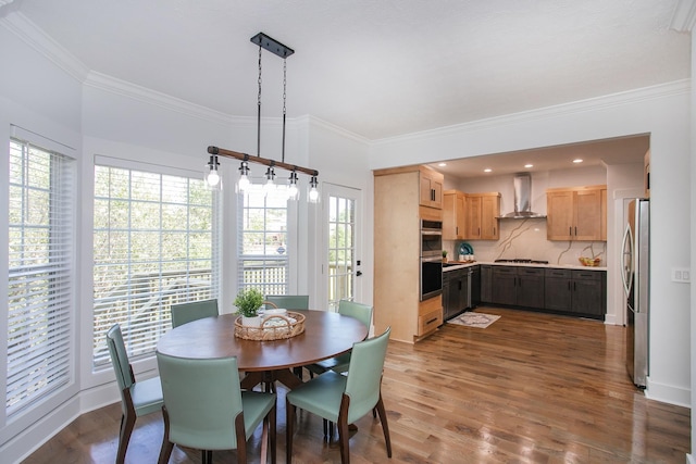 dining room featuring ornamental molding, dark hardwood / wood-style flooring, and a wealth of natural light