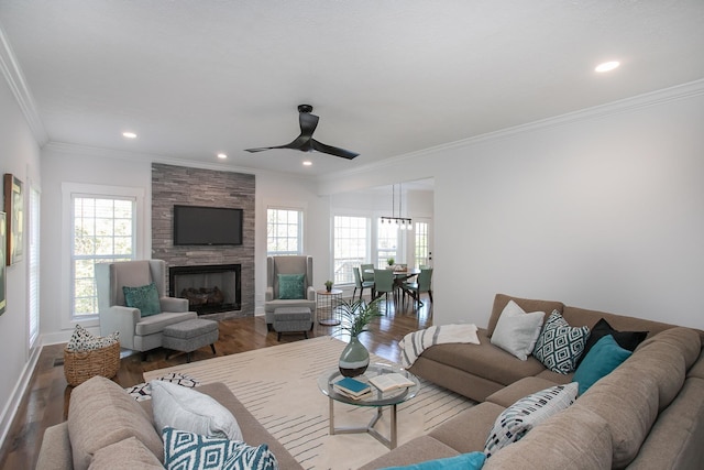 living room featuring crown molding, a fireplace, and hardwood / wood-style flooring