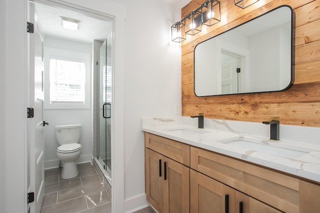 bathroom with vanity, tile patterned flooring, an enclosed shower, and toilet