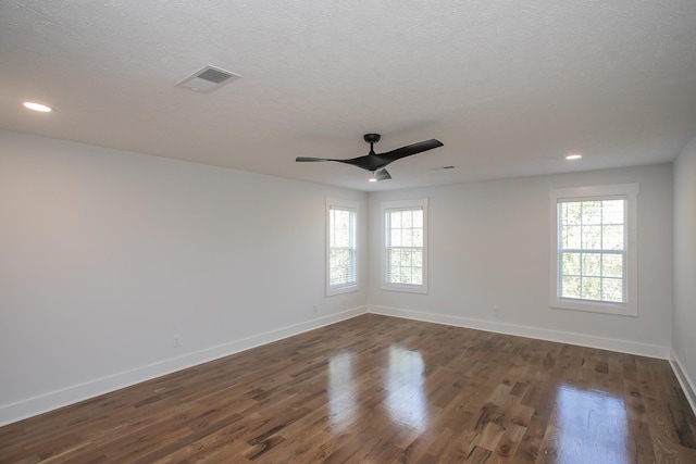 unfurnished room featuring a textured ceiling, dark hardwood / wood-style flooring, and ceiling fan