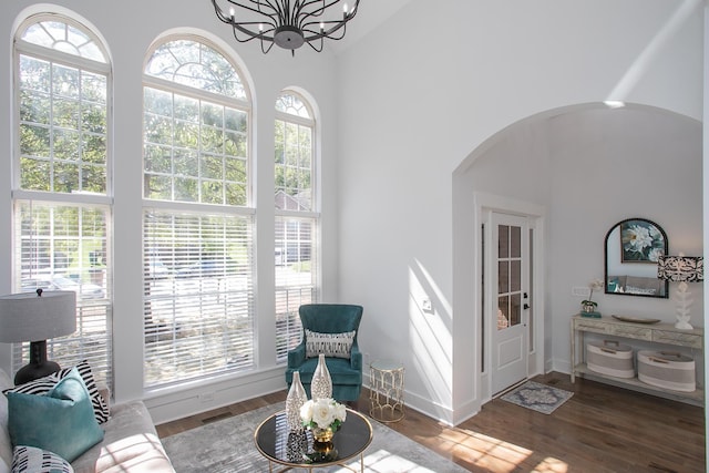 sitting room with dark hardwood / wood-style floors, a chandelier, and plenty of natural light