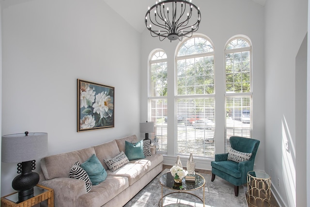 living room featuring a notable chandelier and high vaulted ceiling