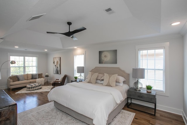 bedroom featuring hardwood / wood-style floors, multiple windows, ceiling fan, and crown molding