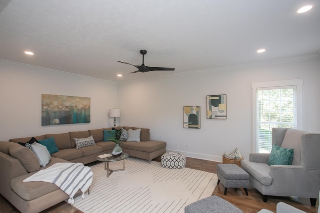 living room with crown molding, ceiling fan, and hardwood / wood-style flooring