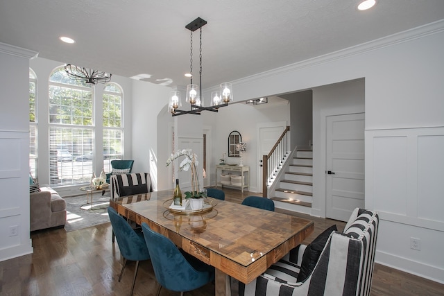 dining space featuring a notable chandelier, a wealth of natural light, dark wood-type flooring, and crown molding