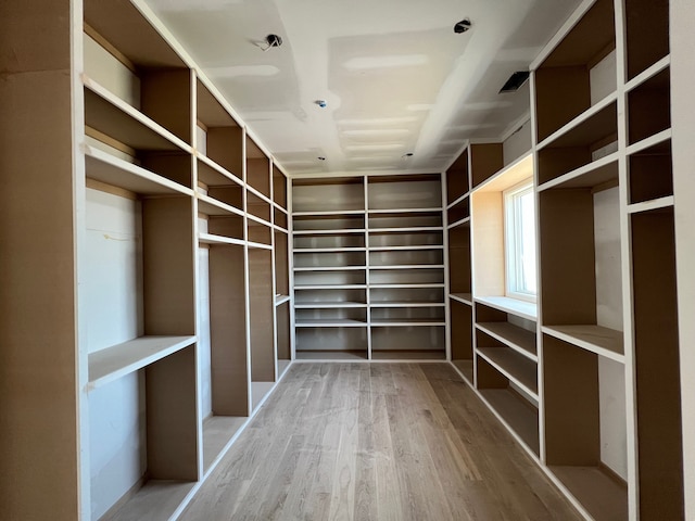 walk in closet featuring hardwood / wood-style flooring