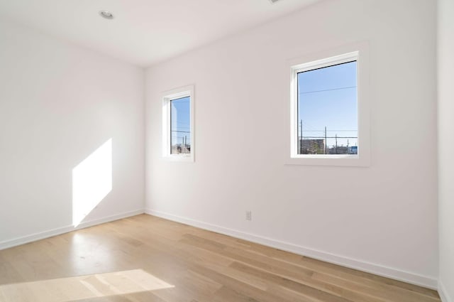 unfurnished room featuring light wood-style flooring and baseboards