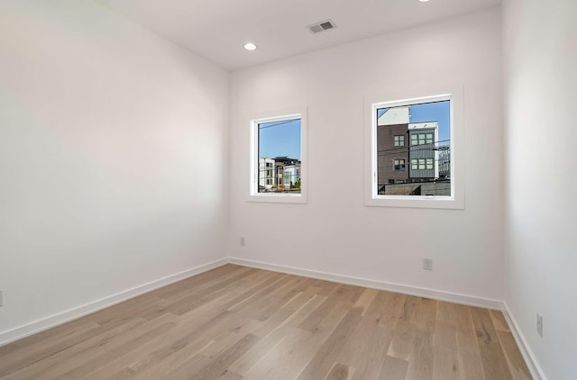 spare room featuring recessed lighting, visible vents, baseboards, and light wood-style floors