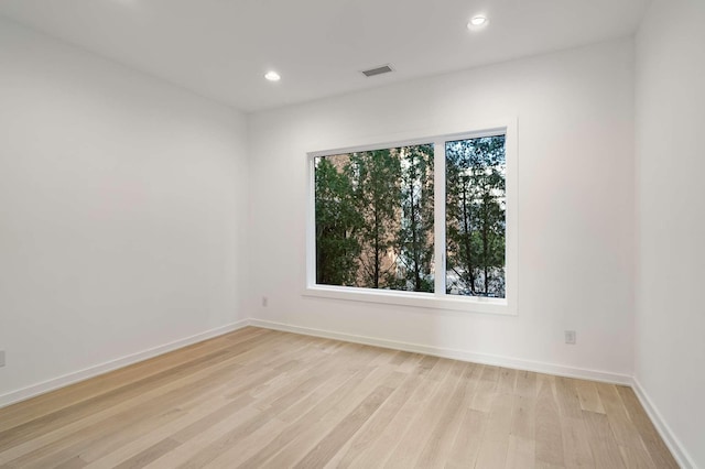 unfurnished room with light wood finished floors, visible vents, recessed lighting, and baseboards