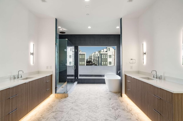 full bathroom with a sink, a soaking tub, two vanities, and a shower stall