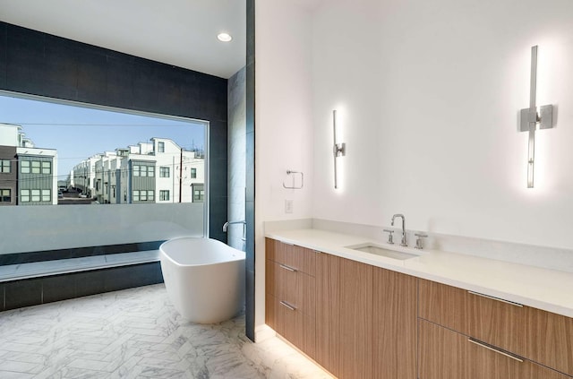 full bath featuring a freestanding tub and vanity