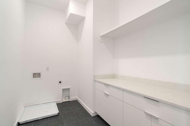 laundry room featuring baseboards, dark tile patterned floors, laundry area, hookup for a washing machine, and hookup for an electric dryer