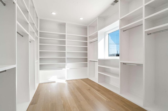 spacious closet featuring light wood-type flooring and visible vents