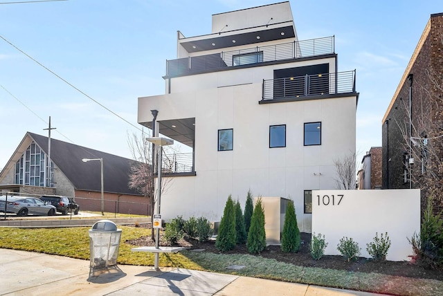 exterior space featuring stucco siding and a balcony