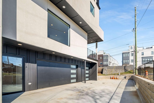 view of patio / terrace featuring a garage and fence