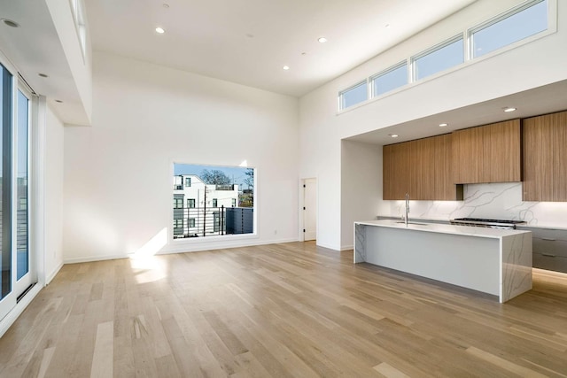 kitchen featuring light countertops, light wood-style flooring, modern cabinets, and brown cabinets