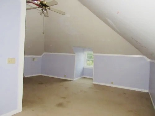 bonus room featuring ceiling fan, light colored carpet, and vaulted ceiling